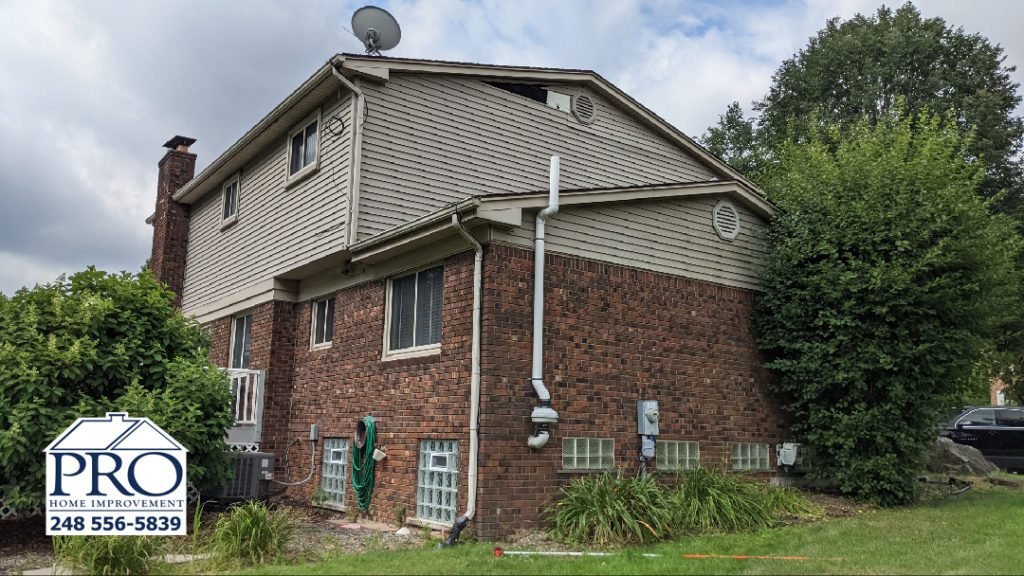 Troy Siding & Gutters Replacement - Back Left Before