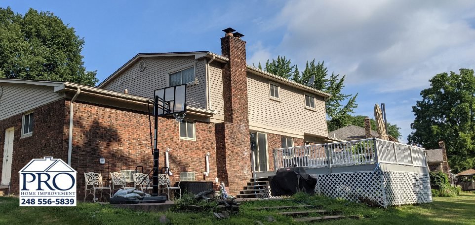 Troy Siding & Gutters Replacement - Back Right Before